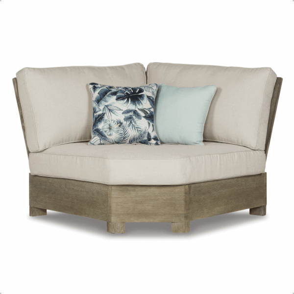 The Silo Point Grouping 5 piece is a beige cushioned corner sectional with a wooden base, including two decorative pillows—one with a blue tropical leaf design and one in solid light blue.