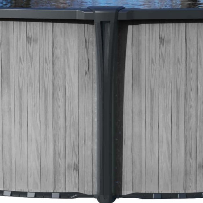 Close-up of the side of the 18 x 54 Montana Pool Package featuring a light gray wood panel design and dark vertical support beams, with water reflections visible along the top edge.