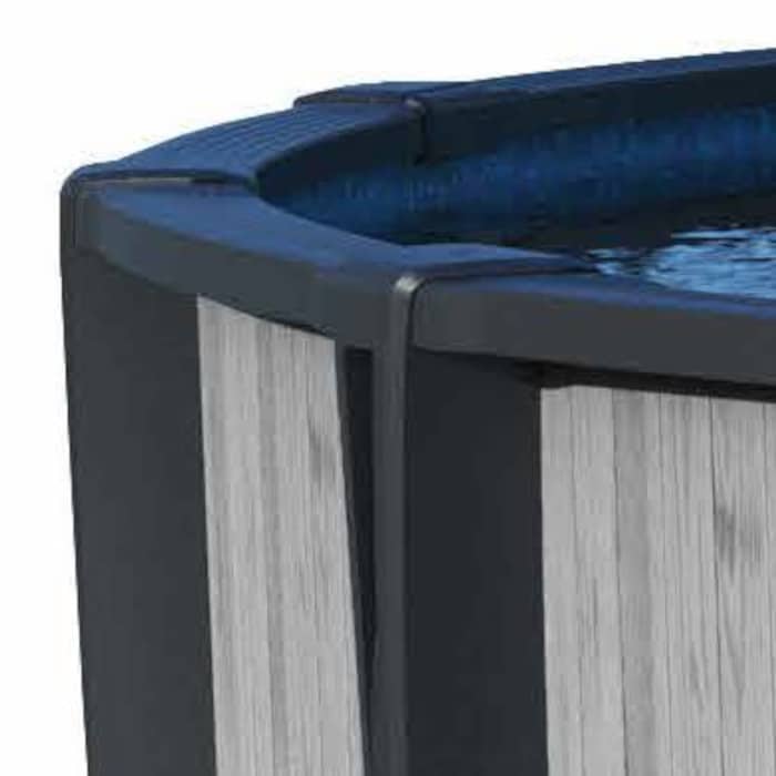 Close-up of the 18 x 54 Montana Pool Package showing its textured gray and black exterior with blue water inside.
