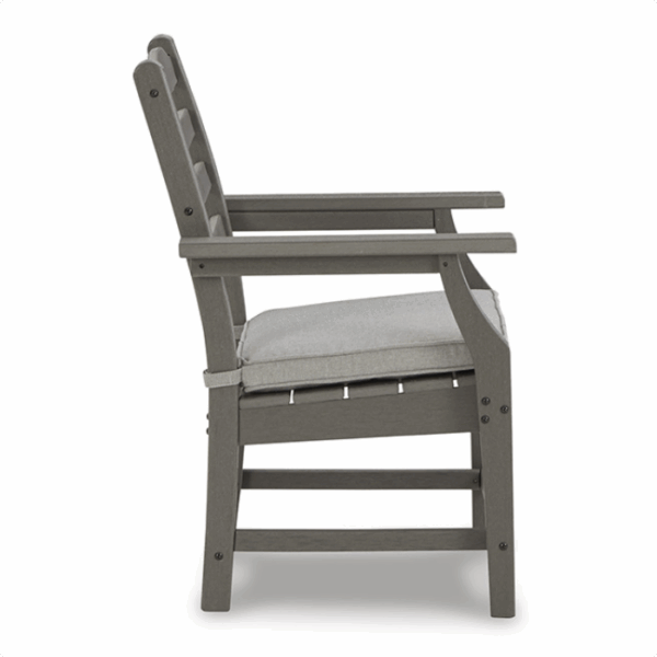Side view of a gray Visola Dining Set 7 piece armchair, featuring a cushioned seat, slatted backrest, straight armrests, and sturdy legs.